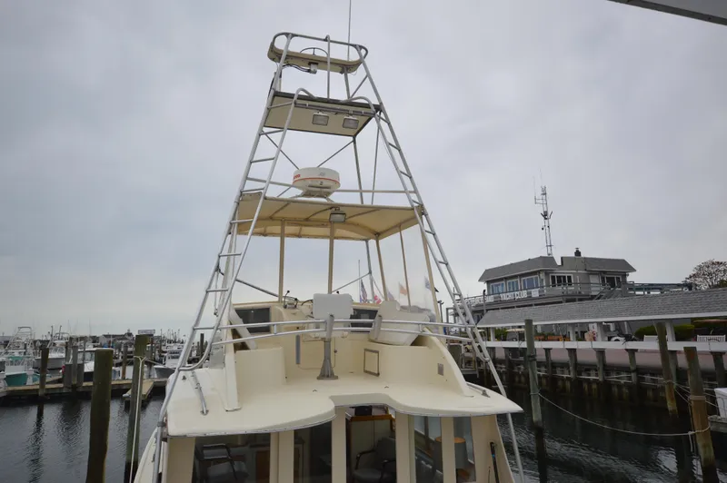 Slide: The Image of 1961 Hatteras 41 Convertible boat docked at a marina. - 4