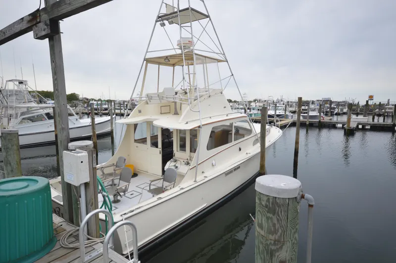 Slide: The Image of 1961 Hatteras 41 Convertible yacht docked at a marina. - 6