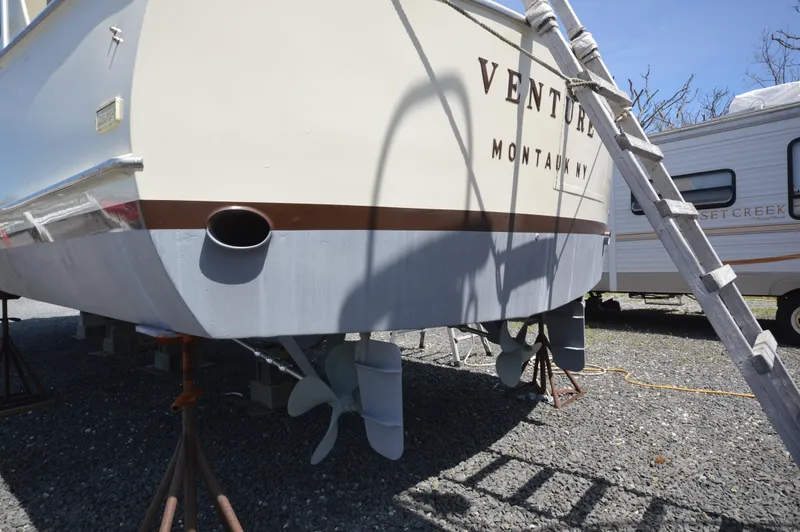 Slide: The Image of 1961 Hatteras 41 Convertible boat on dry dock, rear view with visible propellers. - 9