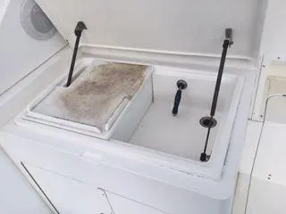 Slide: The Image of 1996 Hatteras SPORTFISH EXPRESS cooler compartment with open lid and storage space. - 11