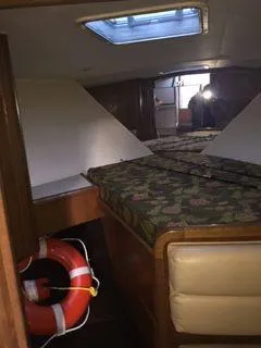 Slide: The Image of Interior cabin of 1996 Hatteras SPORTFISH EXPRESS with floral bedding and life preserver. - 16