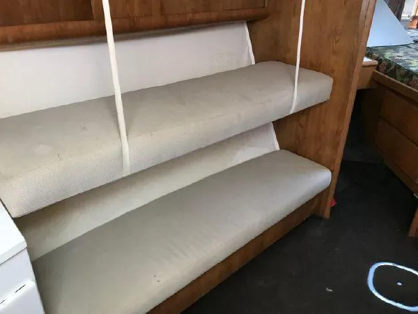 Slide: The Image of Interior of 1996 Hatteras SPORTFISH EXPRESS with bunk beds and wooden cabinetry. - 17