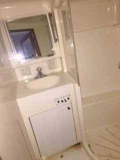 Slide: The Image of Bathroom interior of 1996 Hatteras SPORTFISH EXPRESS yacht, featuring sink and mirror. - 19