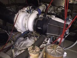 Slide: The Image of Engine room of 1996 Hatteras SPORTFISH EXPRESS with visible components and wiring. - 25