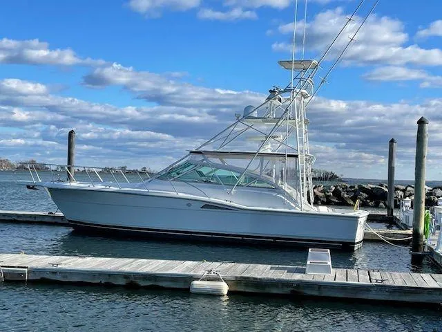 Slide: The Image of 1996 Hatteras SPORTFISH EXPRESS docked at marina under blue sky. - 29