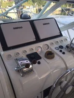 Slide: The Image of 1996 Hatteras SPORTFISH EXPRESS helm with Simrad displays and gauges. - 6