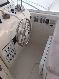 Slide: The Image of 1996 Hatteras SPORTFISH EXPRESS helm with steering wheel and control panel. - 7