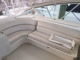 Slide: The Image of 1996 Hatteras SPORTFISH EXPRESS interior seating area with white cushioned benches. - 8