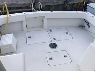 Slide: The Image of 1996 Hatteras SPORTFISH EXPRESS boat deck with storage hatches and seating. - 9