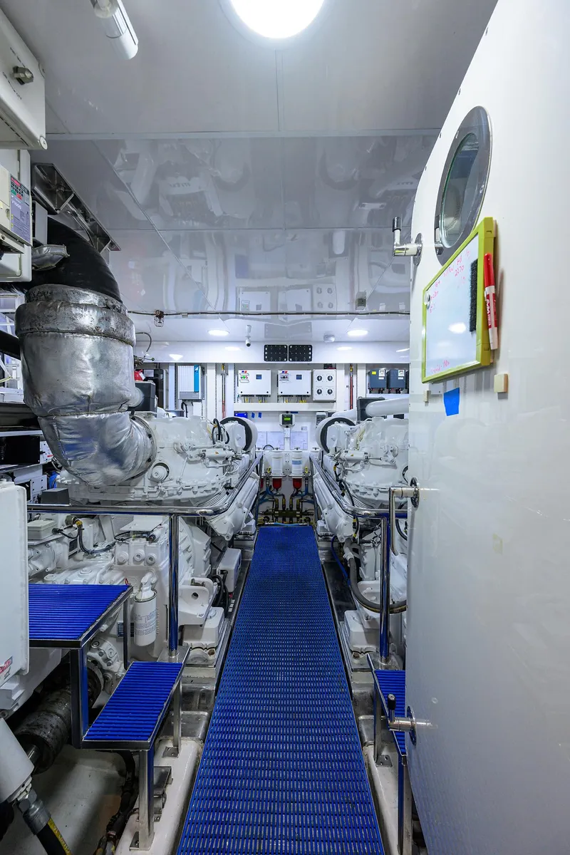 Slide: The Image of Engine room of 2013 Ocean Alexander Sky Lounge yacht, featuring dual engines and control panels. - 100