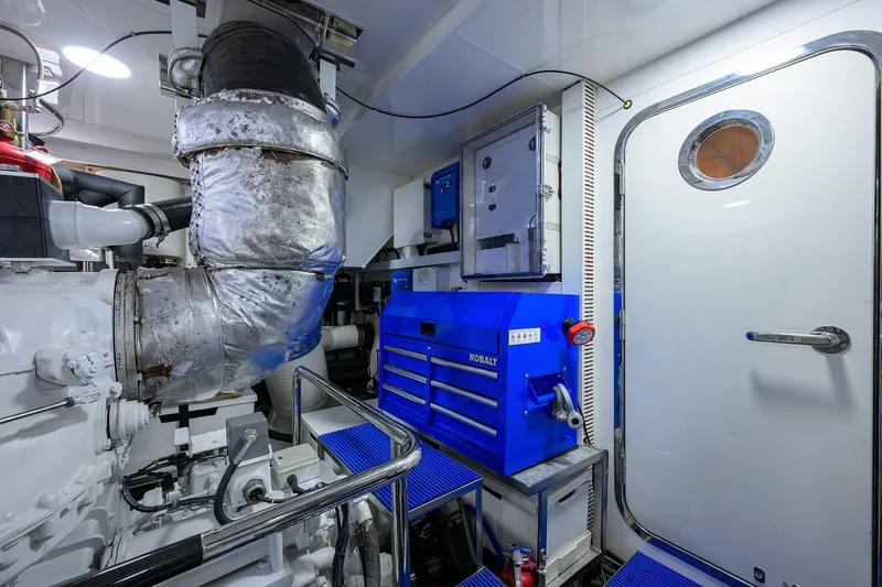Slide: The Image of Engine room of 2013 Ocean Alexander Sky Lounge yacht with blue tool chest and insulated pipes. - 105