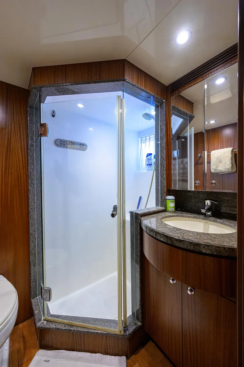 Slide: The Image of Luxurious bathroom in 2013 Ocean Alexander Sky Lounge yacht with glass shower and elegant wood finishes. - 12