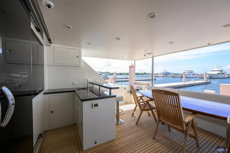 Slide: The Image of Luxurious 2013 Ocean Alexander Sky Lounge yacht deck with seating and marina view. - 15