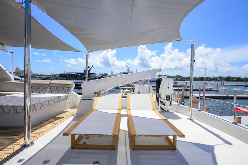 Slide: The Image of 2013 Ocean Alexander Sky Lounge yacht deck with sun loungers and marina view. - 21