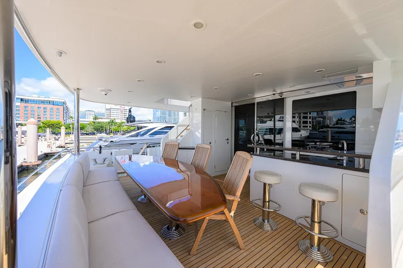 Slide: The Image of Luxurious 2013 Ocean Alexander Sky Lounge yacht deck with seating, table, and bar stools. - 25