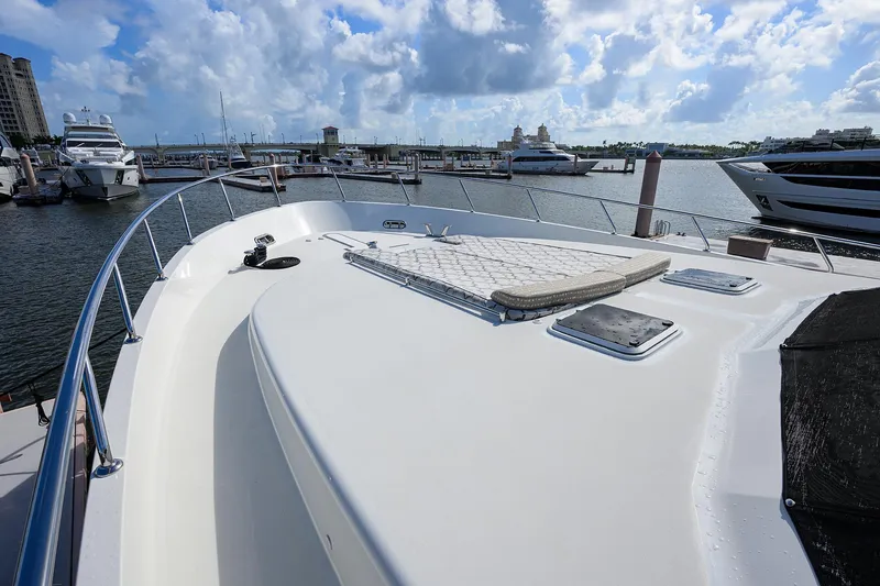 Slide: The Image of 2013 Ocean Alexander Sky Lounge yacht deck with marina view, featuring sleek design and spacious layout. - 57