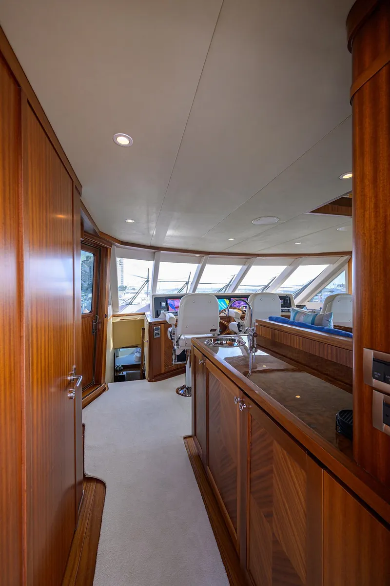 Slide: The Image of Luxurious 2013 Ocean Alexander Sky Lounge interior with wood paneling and modern helm. - 59