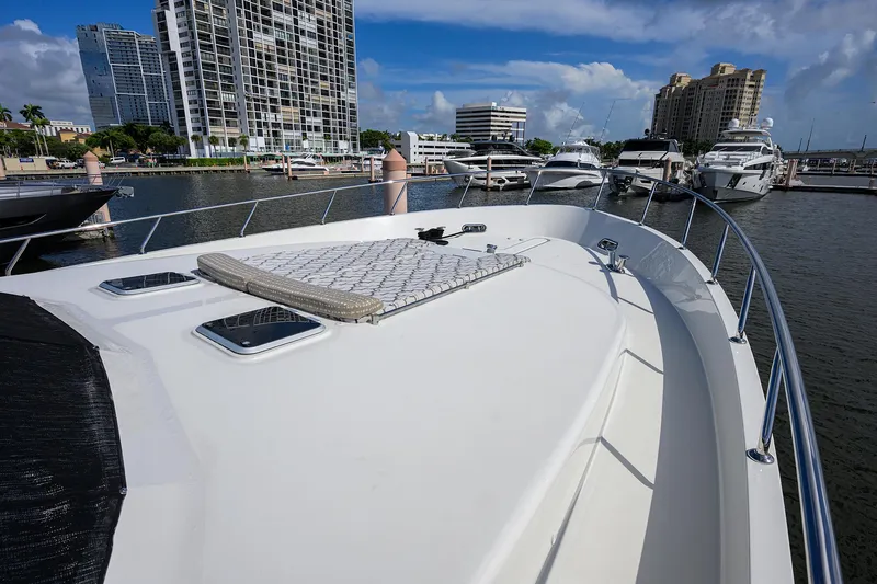 Slide: The Image of 2013 Ocean Alexander Sky Lounge yacht docked in marina, with cityscape background. - 69