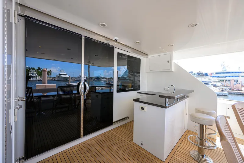 Slide: The Image of Luxurious 2013 Ocean Alexander Sky Lounge yacht with sleek outdoor bar and marina view. - 8