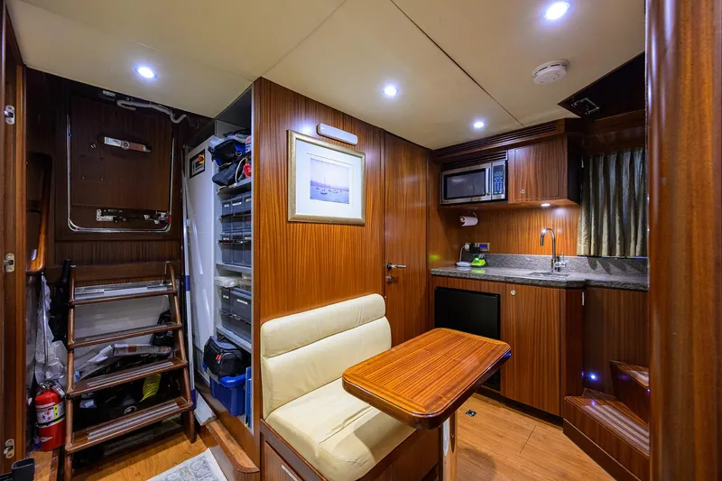 Slide: The Image of Luxurious 2013 Ocean Alexander Sky Lounge interior with kitchenette, seating, and storage. - 81