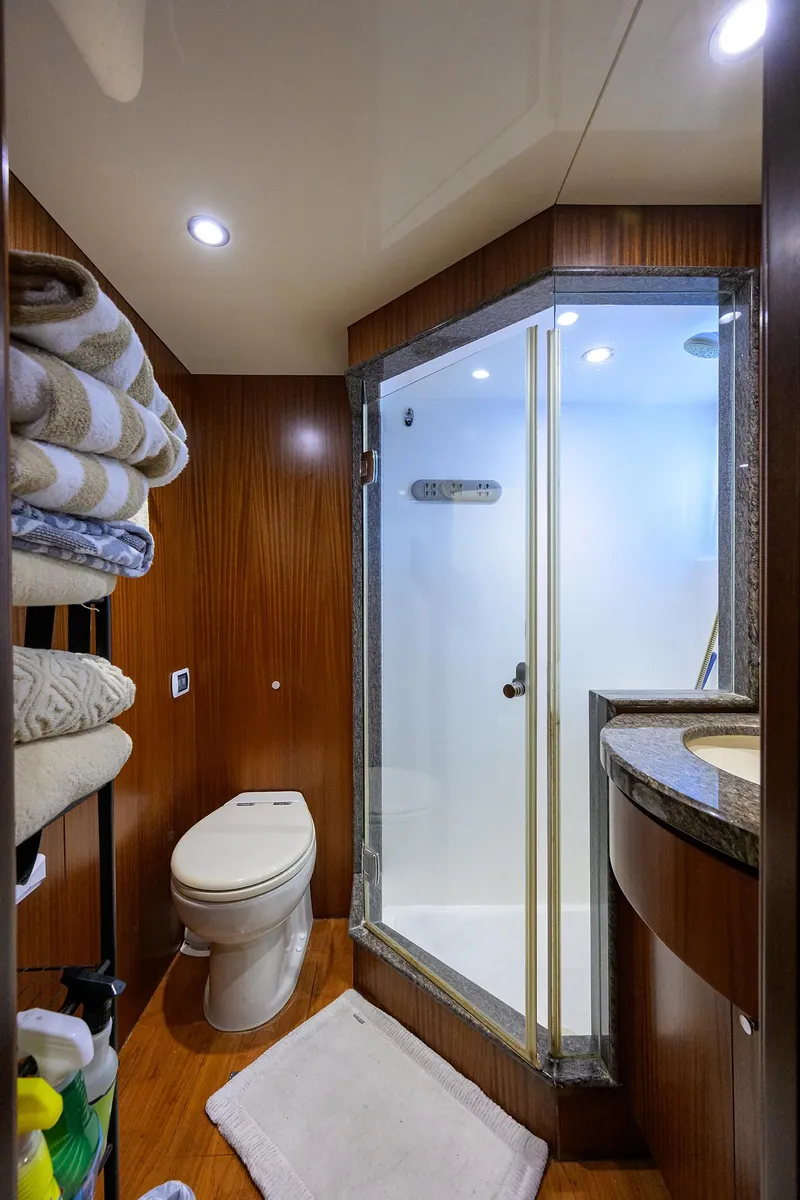 Slide: The Image of Luxurious bathroom in 2013 Ocean Alexander Sky Lounge yacht with shower and wooden accents. - 91