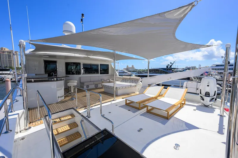 Slide: The Image of Luxurious 2013 Ocean Alexander Sky Lounge yacht deck with sun loungers and shaded seating area. - 10