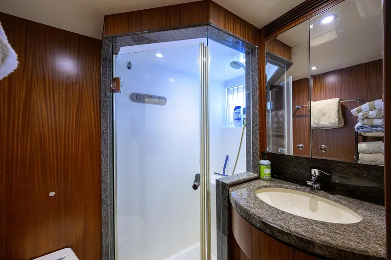 Slide: The Image of Luxurious bathroom in 2013 Ocean Alexander Sky Lounge yacht with modern shower and elegant wood finishes. - 17