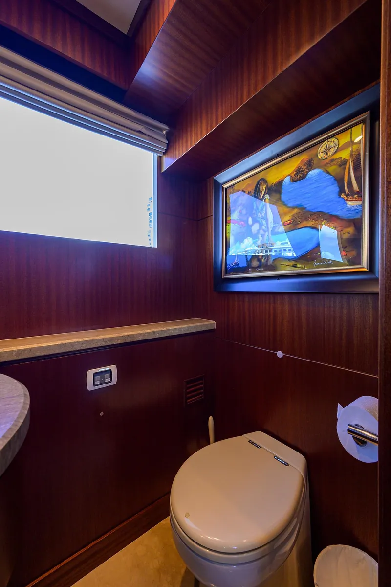 Slide: The Image of Luxurious bathroom in 2013 Ocean Alexander Sky Lounge yacht with elegant wood paneling and artwork. - 22