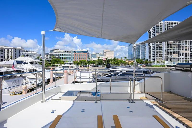Slide: The Image of 2013 Ocean Alexander Sky Lounge yacht docked in a marina with cityscape background. - 26