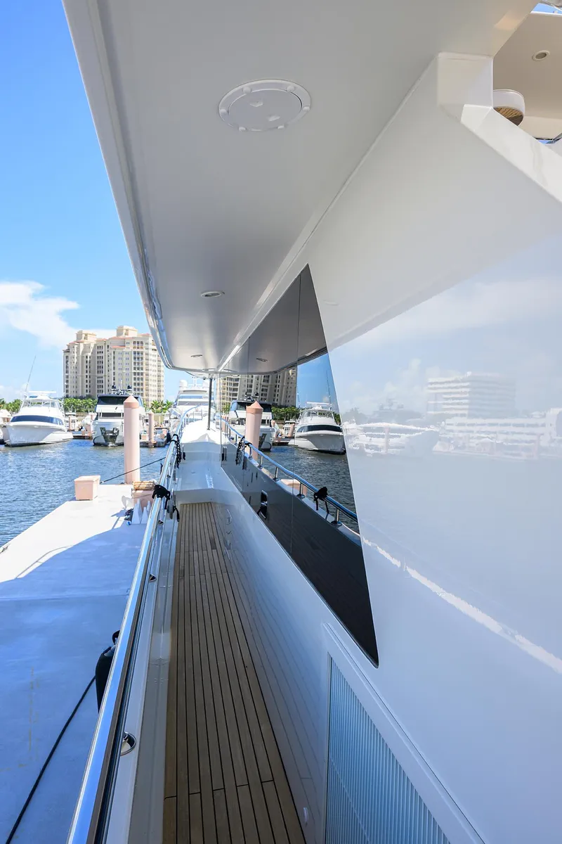 Slide: The Image of 2013 Ocean Alexander Sky Lounge yacht docked at marina, showcasing sleek design and wooden deck. - 55