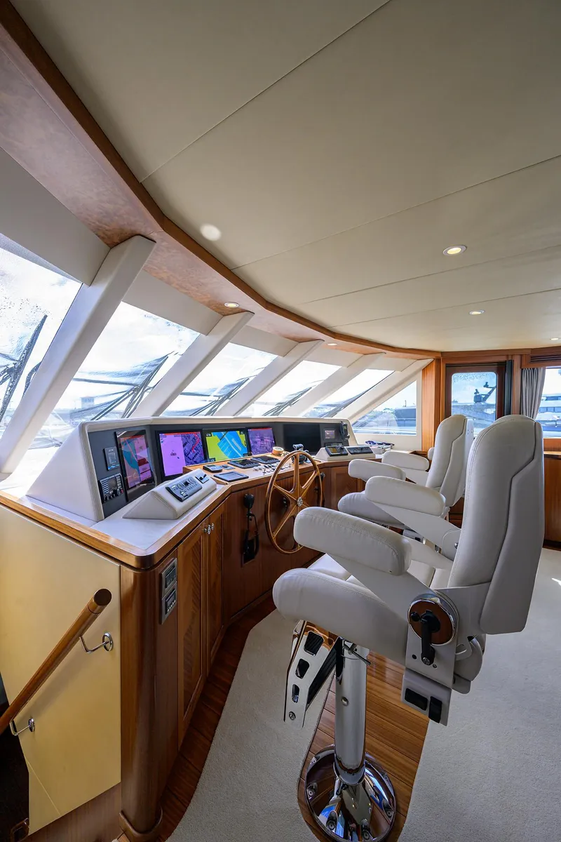 Slide: The Image of Luxurious 2013 Ocean Alexander Sky Lounge interior with modern navigation equipment and plush seating. - 66