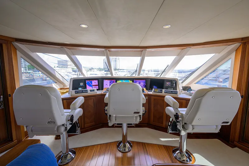 Slide: The Image of Luxurious 2013 Ocean Alexander Sky Lounge yacht helm with three captain chairs and advanced navigation systems. - 74