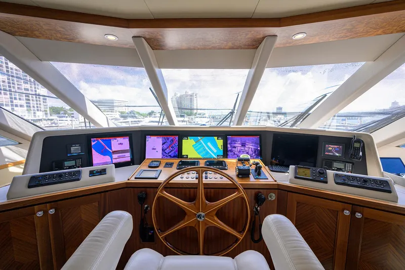 Slide: The Image of Helm of 2013 Ocean Alexander Sky Lounge yacht with navigation screens and wooden steering wheel. - 75