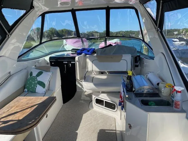Slide: The Image of Interior of a 2010 Sea Ray 310 Sundancer boat with seating and kitchenette. - 19