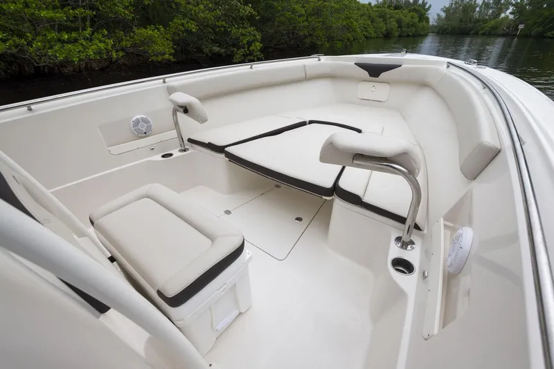 Slide: The Image of 2024 Sailfish 320 CC boat interior with cushioned seating and storage compartments. - 11