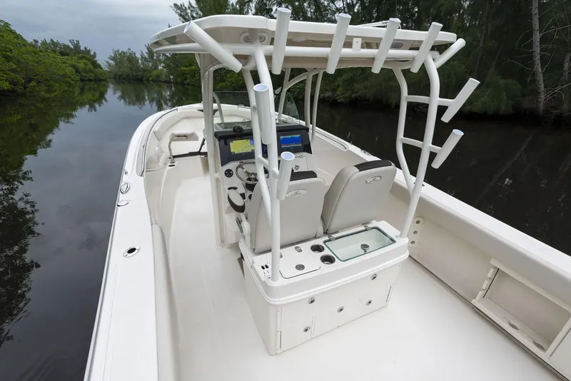 Slide: The Image of 2024 Sailfish 320 CC boat interior with dual seats and navigation equipment. - 12
