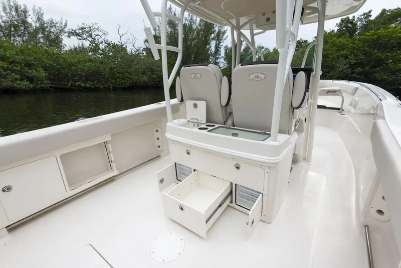 Slide: The Image of 2024 Sailfish 320 CC boat interior with storage compartments and seating. - 18