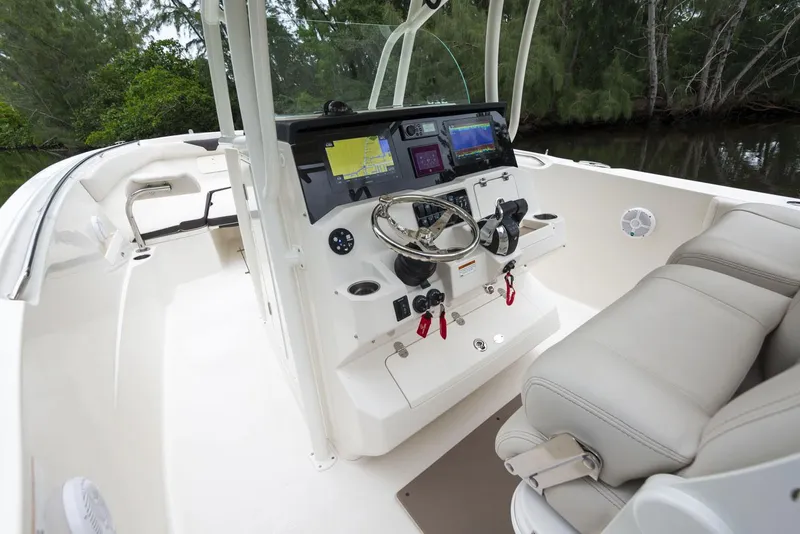 Slide: The Image of 2024 Sailfish 320 CC boat cockpit with modern navigation system and comfortable seating. - 3