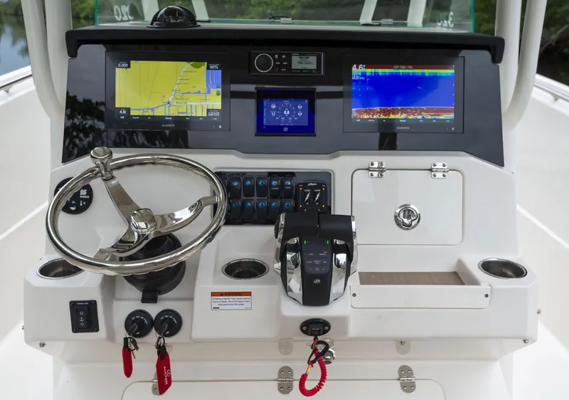 Slide: The Image of 2024 Sailfish 320 CC boat dashboard with navigation and control systems. - 4