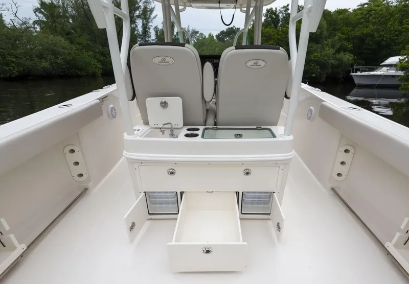 Slide: The Image of 2024 Sailfish 320 CC boat interior with storage compartments and seating. - 5