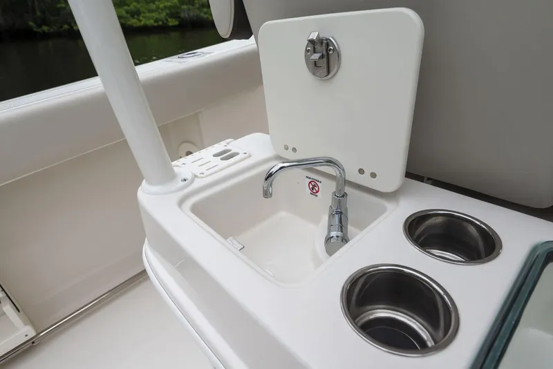 Slide: The Image of Sailfish 320 CC 2024 boat sink and cup holders on deck. - 6