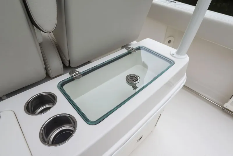 Slide: The Image of 2024 Sailfish 320 CC boat interior with cup holders and storage compartment. - 9