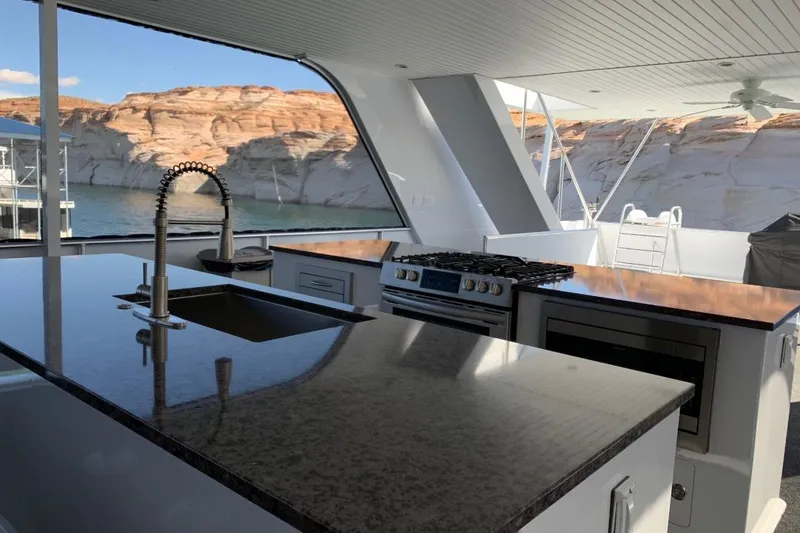 Slide: The Image of Modern kitchen on Adonia Harmony Share 2 yacht, featuring sleek countertops and scenic water views. - 22