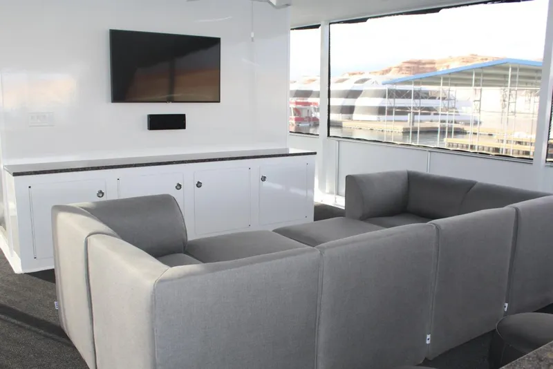 Slide: The Image of Modern living area in Adonia Harmony Share 2, 2020 model, featuring sleek furniture and a wall-mounted TV. - 24