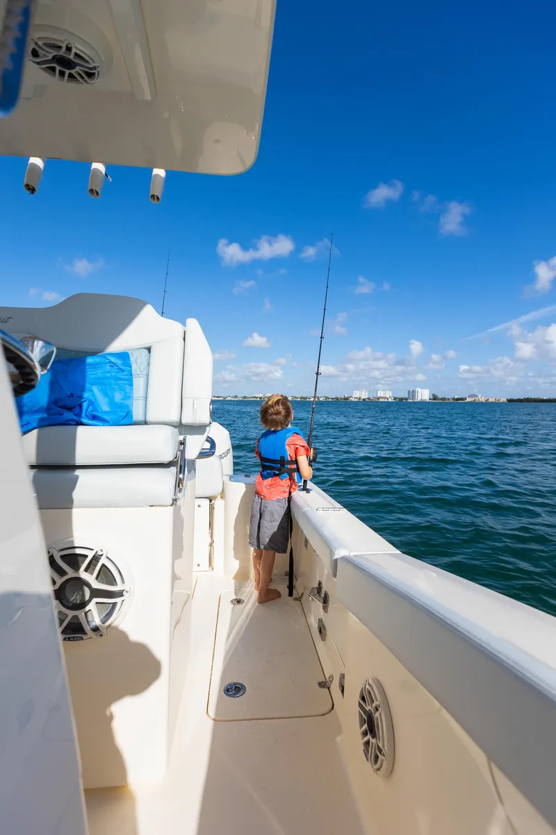 Slide: The Image of Child fishing on a 2026 Scout 260 LXF boat. - 3