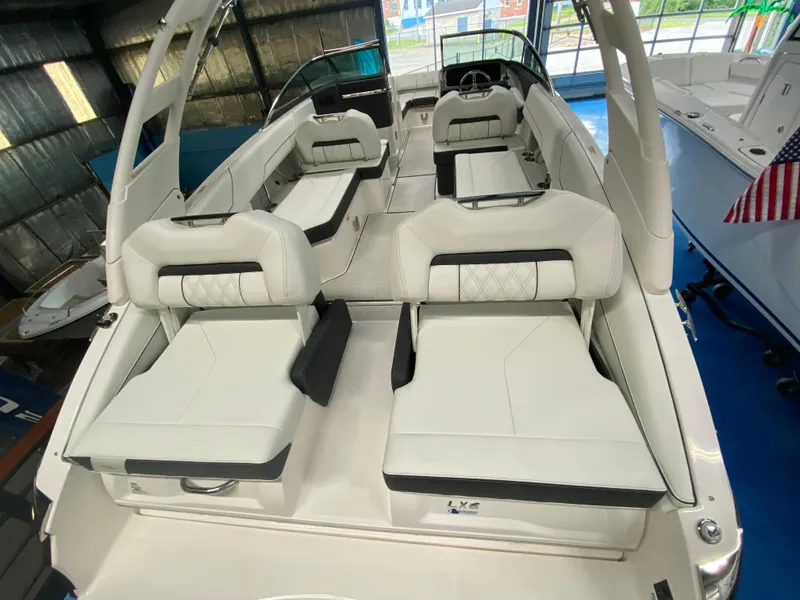 Slide: The Image of Storage compartment in 2026 Regal LX6 boat, containing various items and gear. - 16