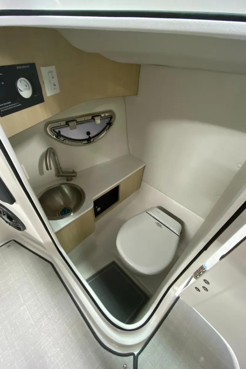 Slide: The Image of 2025 Regal LX6 boat bathroom with sink, toilet, and modern fixtures. - 20