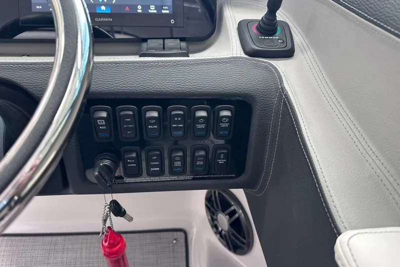 Slide: The Image of 2026 Regal LX6 boat dashboard with control panel and steering wheel. - 23