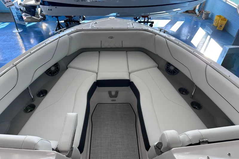 Slide: The Image of 2026 Regal LX6 boat interior with luxurious white seating and cup holders. - 25
