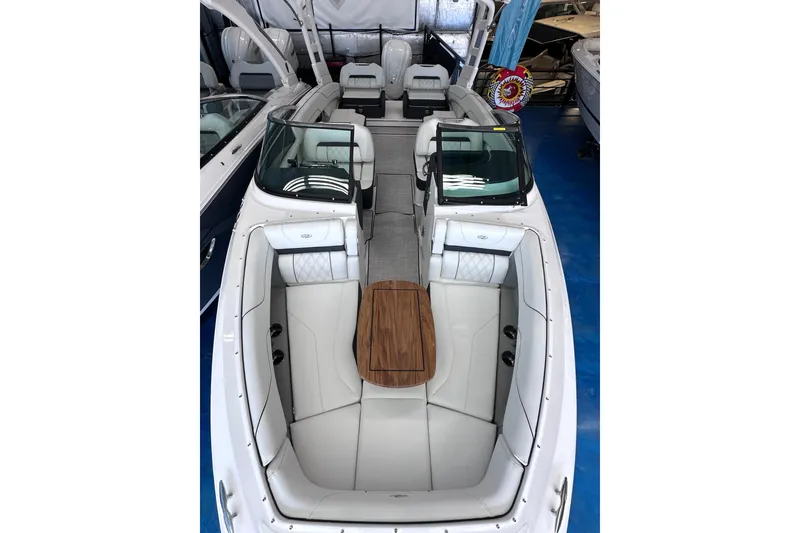 Slide: The Image of 2026 Regal LX6 boat interior with white seating and wooden table. - 35